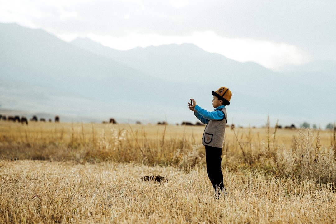 Cameraman filming outdoors in a field