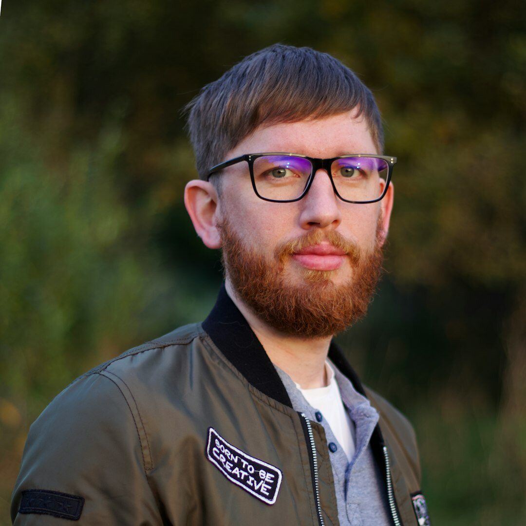 Bearded man with glasses in casual attire